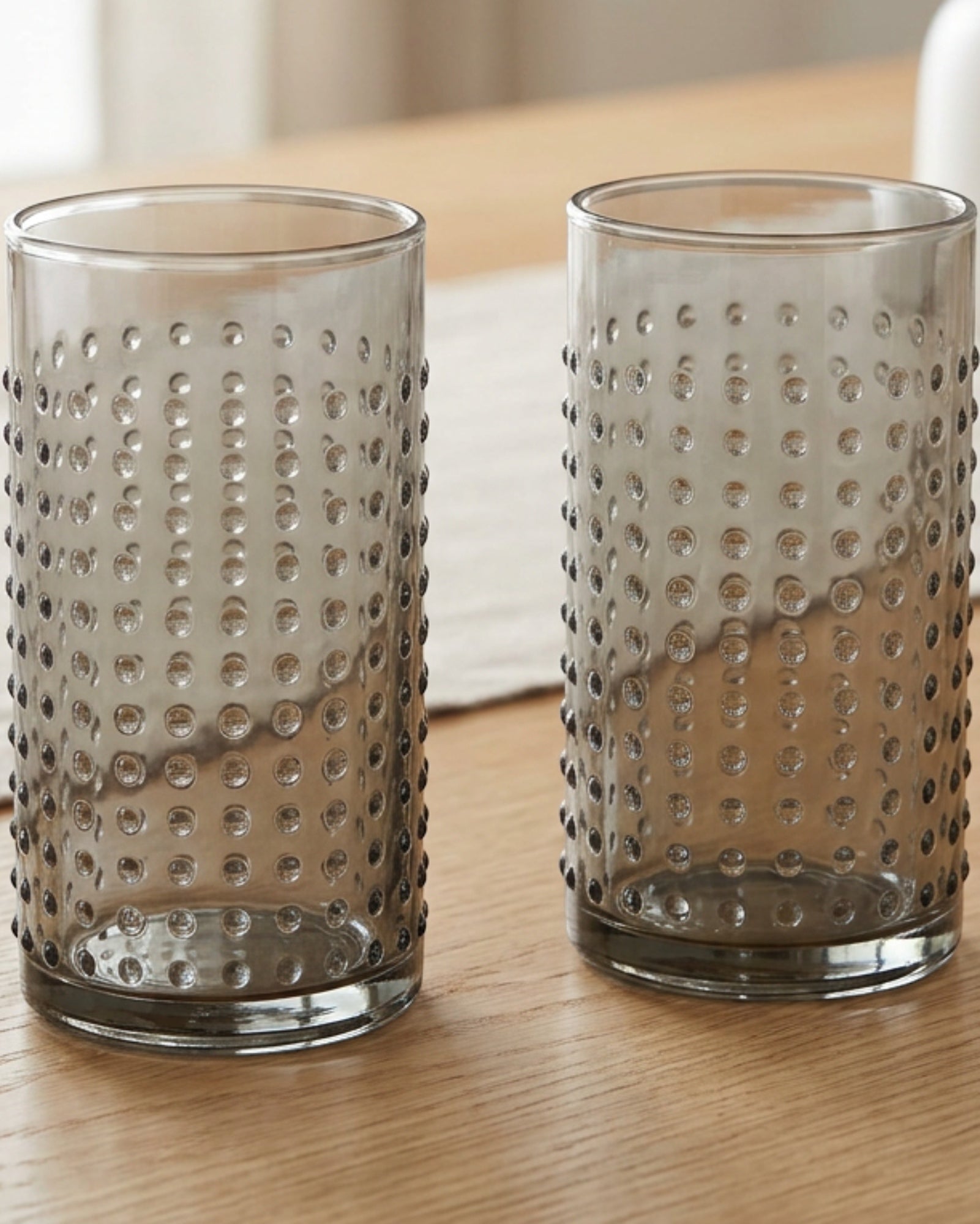 Vibns Dotcrest Smoke Embossed Highball Glasses 13 oz Set of 2 - Lifestyle view
